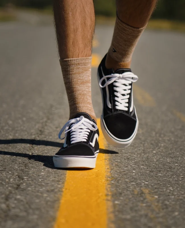 Brand shoot socks: Man wears brown socks, black and white old skool